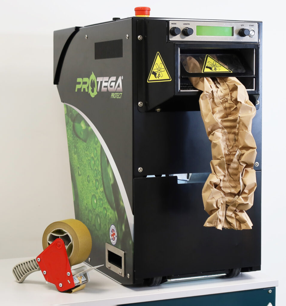 Protega Machine On Bench With Tapes Dispenser